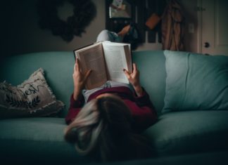 Tips to Help You Read More A woman reading a book.