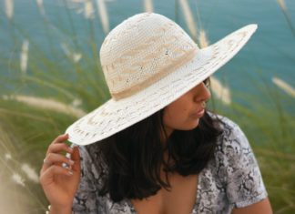 Easy Ways To Protect Your Skin This Summer A woman sitting in the shade