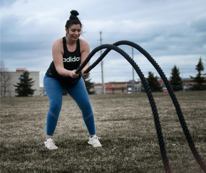 Woman using battle ropes