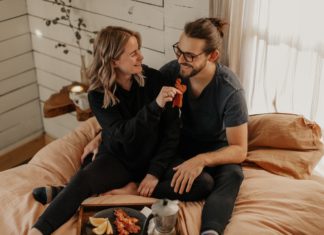 Moving in With Your Partner? Here’s How to Decorate Your Home Couple snuggling together
