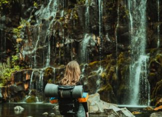 3 Criteria To Consider When Choosing Travel Buddies Girl by a waterfall
