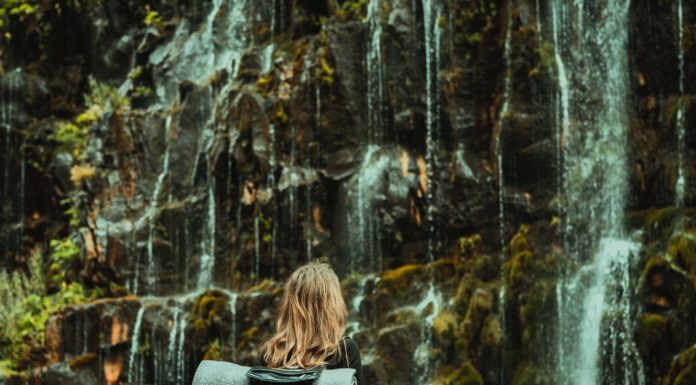 3 Criteria To Consider When Choosing Travel Buddies Girl by a waterfall