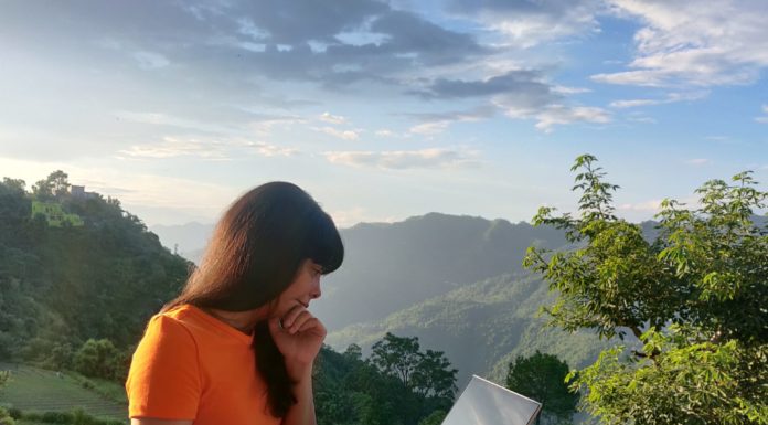 Why You Shouldn’t Do Work On Your Vacation Woman working by balcony