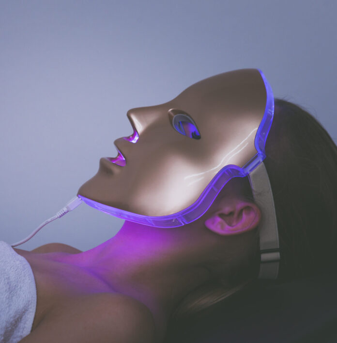 Woman with led light therapy facial beauty mask photon therapy