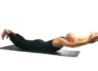 Yoga Pose Makarasana Offers Significant Health Benefits for People Over 50 Man practicing makarasana yoga