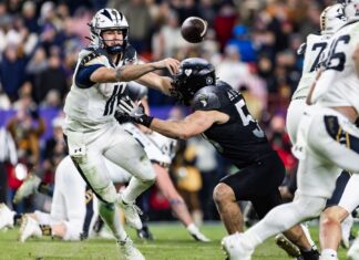 Navy Triumphs Over Army in Decisive 2024 Showdown Navy's BLAKE HORVATH (11) makes a pass before being tackled during the game between Army and Navy.