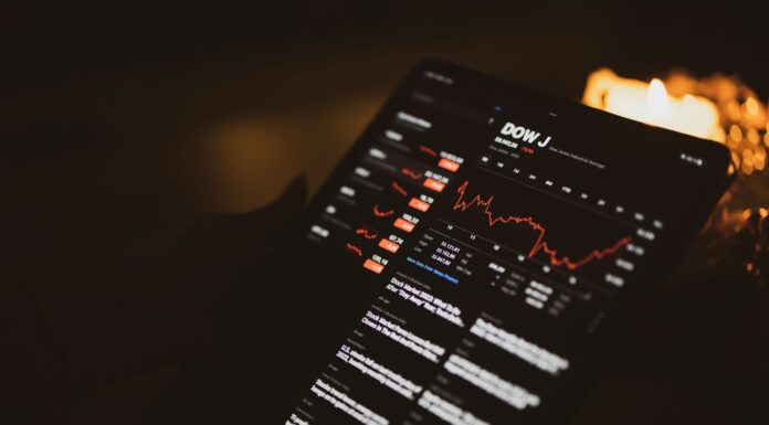 Dow Jones Plummets Over 1,100 Points Following Fed’s Rate Cut Decision A close-up of an iPad screen showing a stocks app